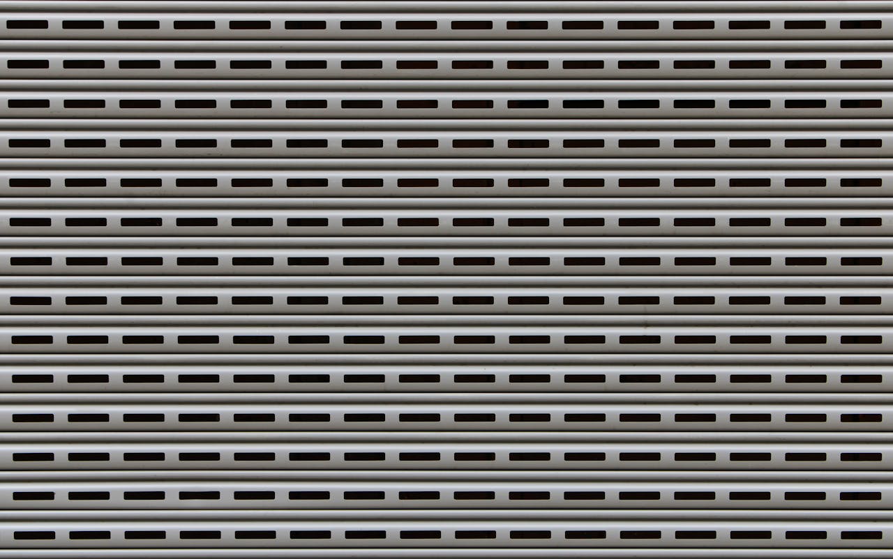 Close-up view of a textured metallic roll-up door showcasing repetitive horizontal patterns.